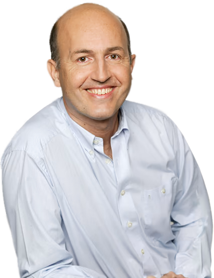Portrait of a smiling middle-aged man in a light blue button-down shirt against a white background.